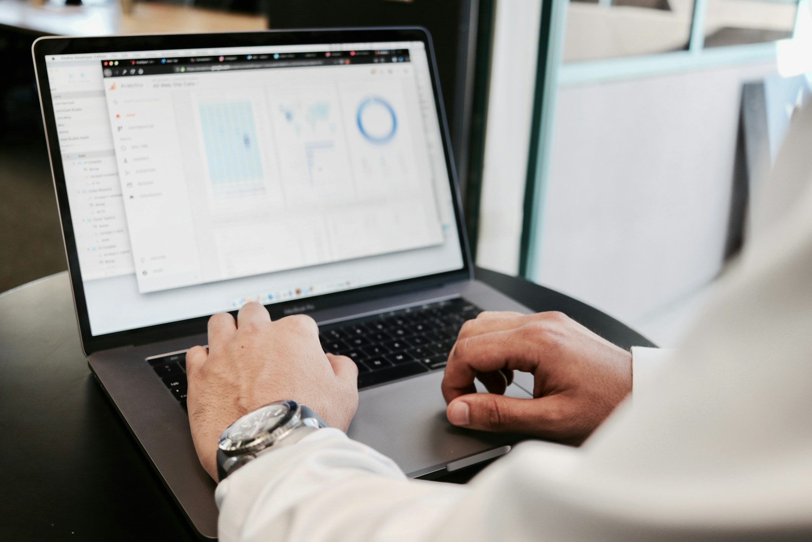 person using MacBook Pro business home